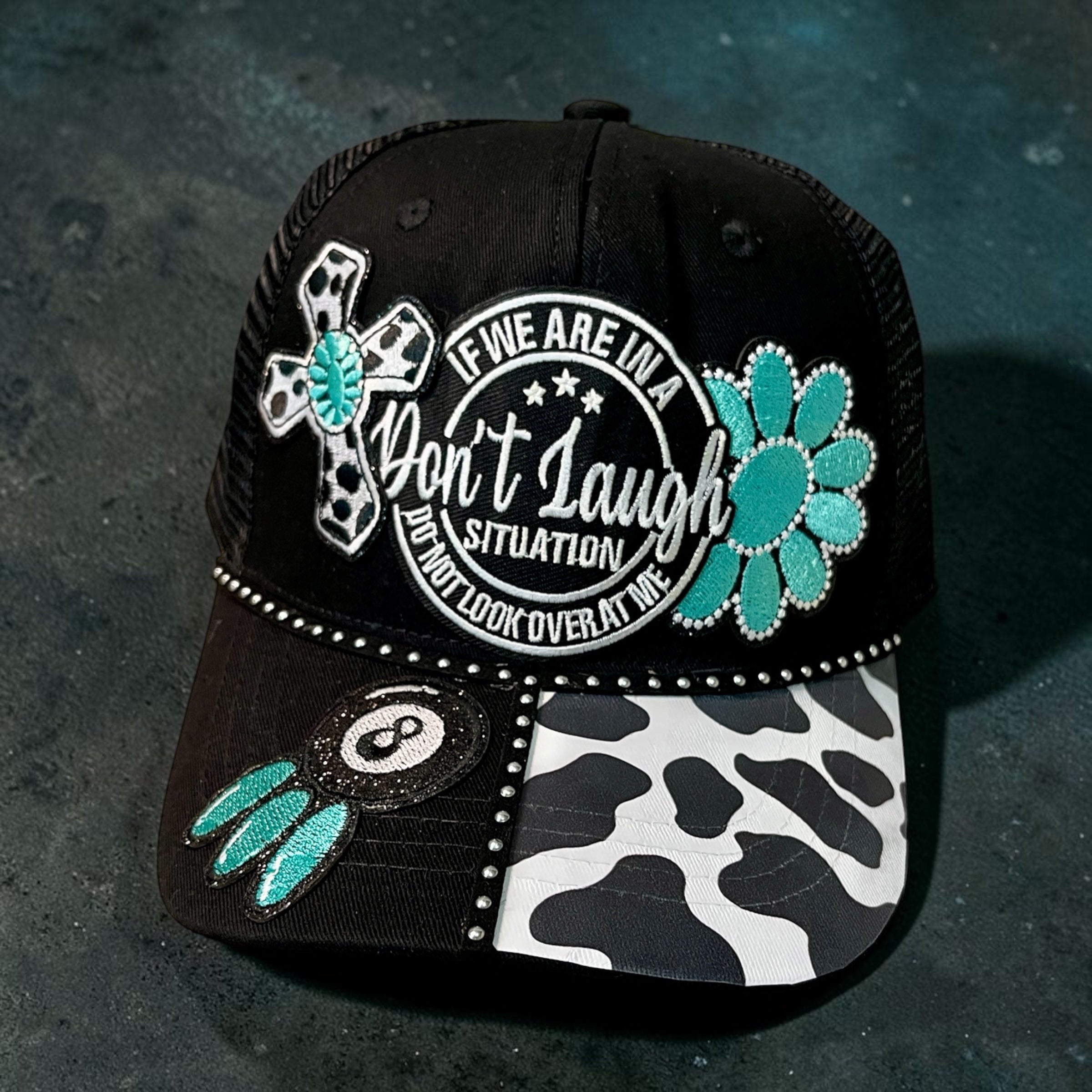 Don't Laugh hat by Southern Brim Works - black cap with turquoise flower, cow print brim, rhinestones, and Don't Laugh situation patch