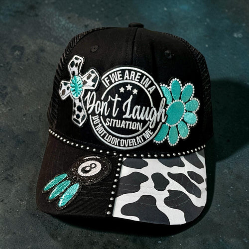Don't Laugh hat by Southern Brim Works - black cap with turquoise flower, cow print brim, rhinestones, and Don't Laugh situation patch